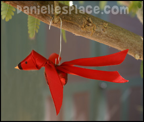 Red Bird Christmas Ornament Craft - Ribbon and Bell Cardinal Craft for Kids from www.daniellesplace.com
